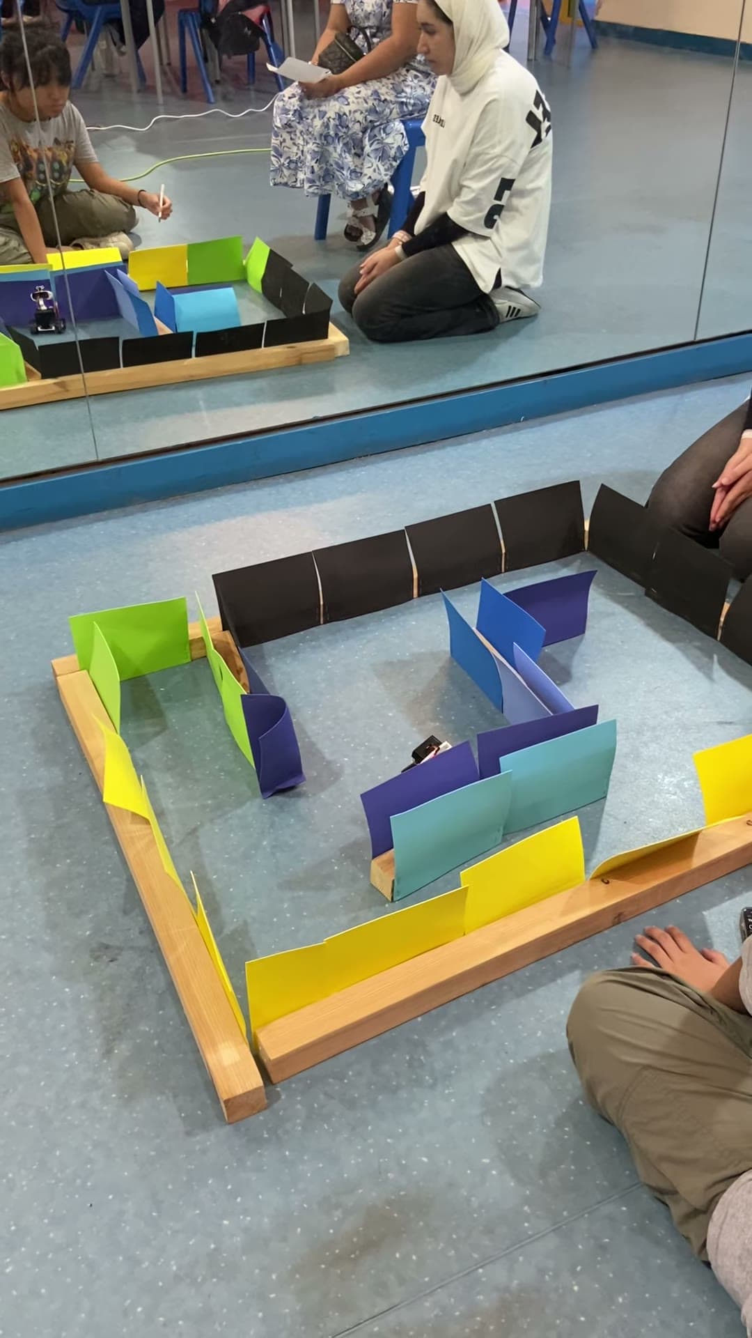 Wall-E robot navigating an overhead maze challenge