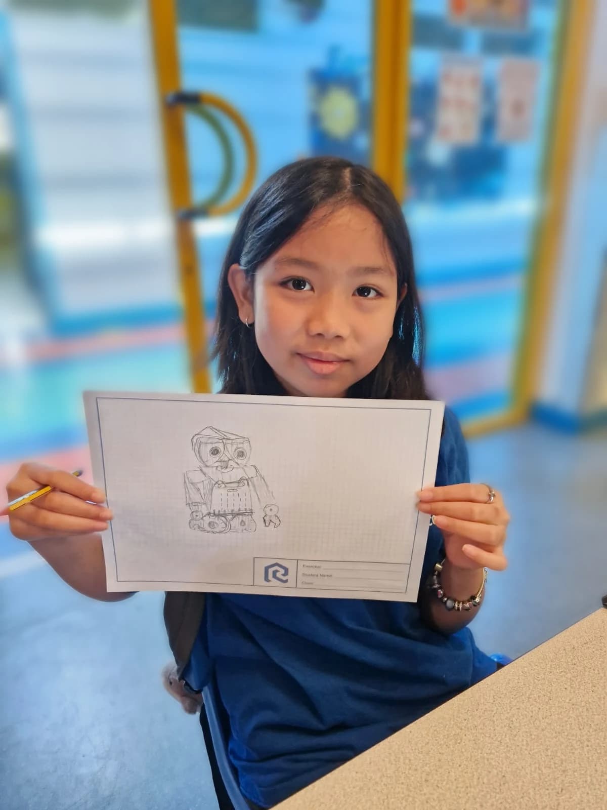 Student sharing a robot concept drawing