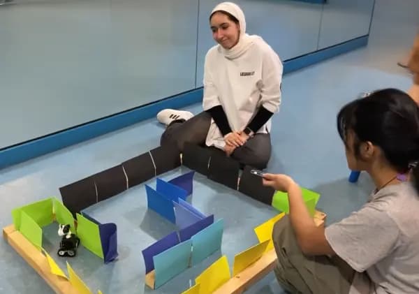 Roboticscool students assembling robot components in class