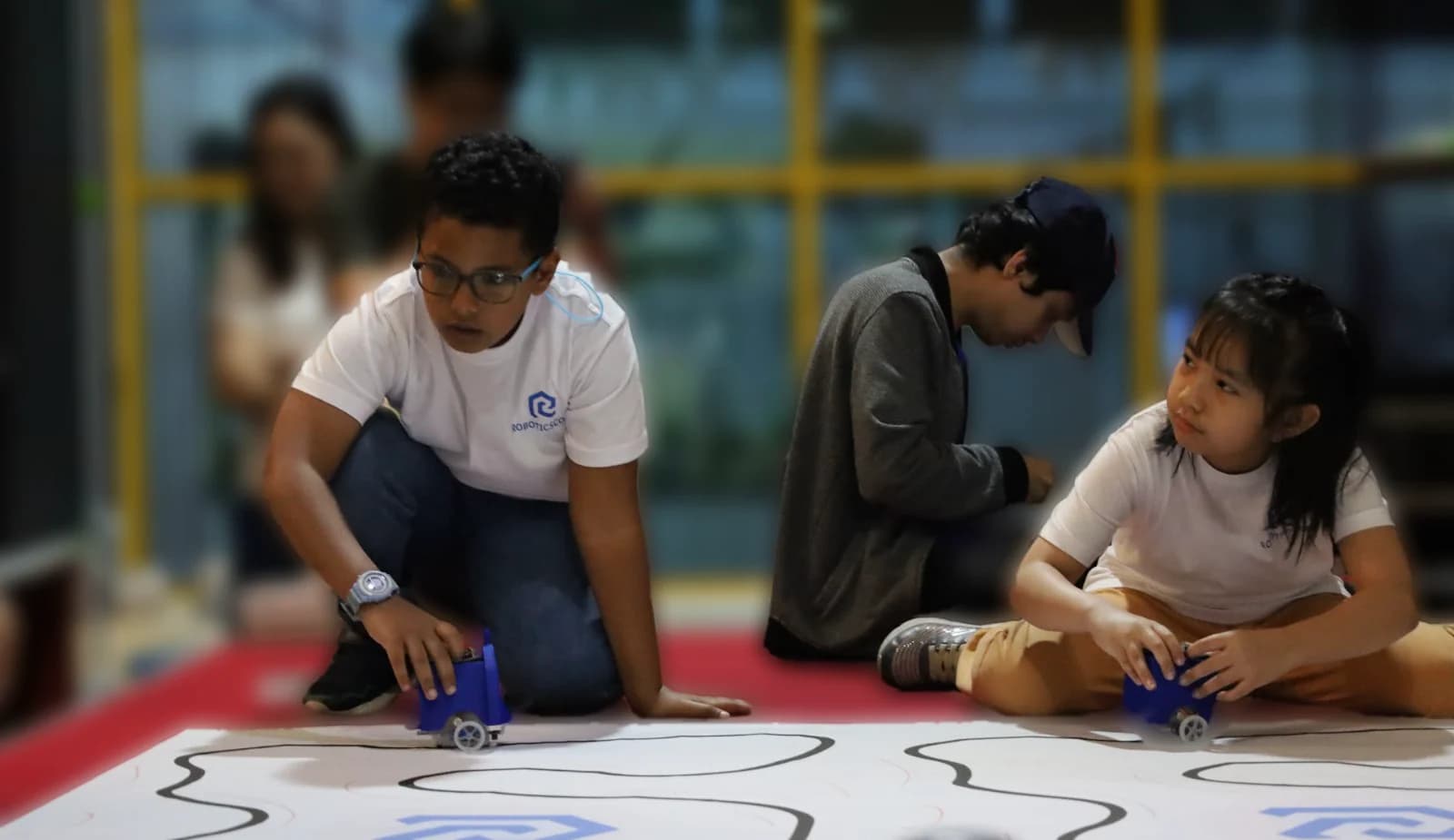 Students testing robots on a line-following track